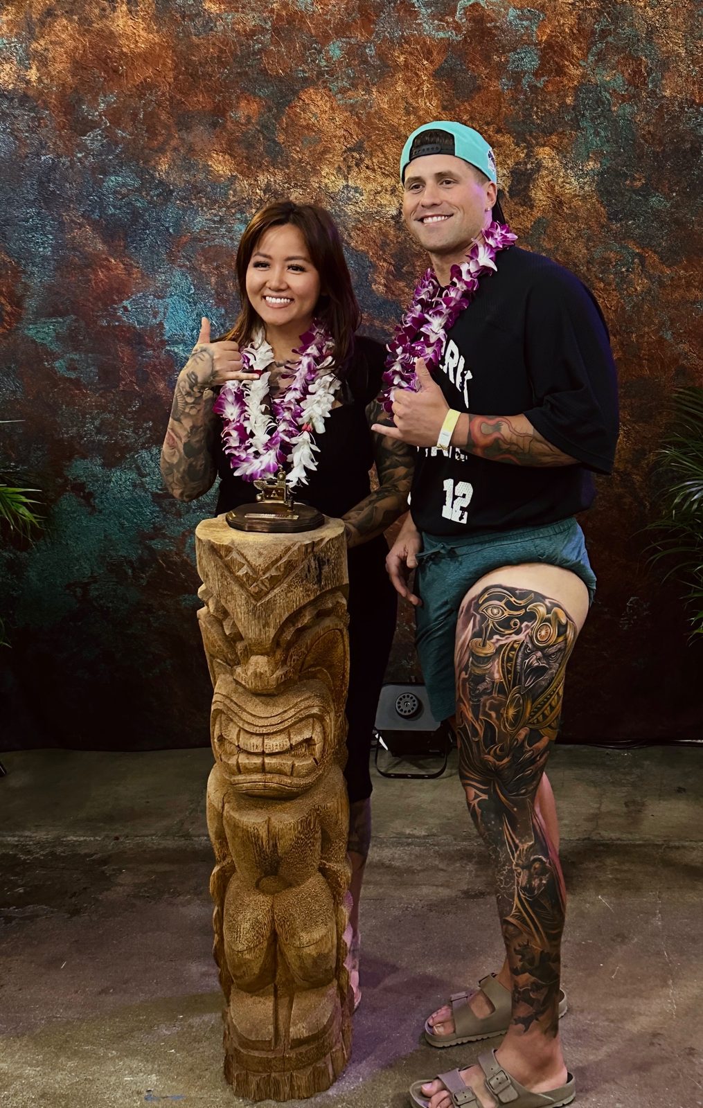 Lynn Hoang and client with trophy and full leg sleeve visible